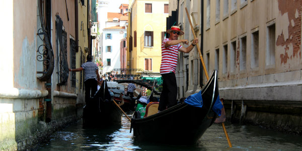 Gondoliers guide travelers through Venice's maze of canals.