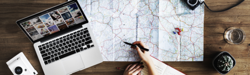 Computer Map On a Desk with someone pointing out a location