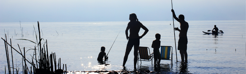 family finishing together at a lake